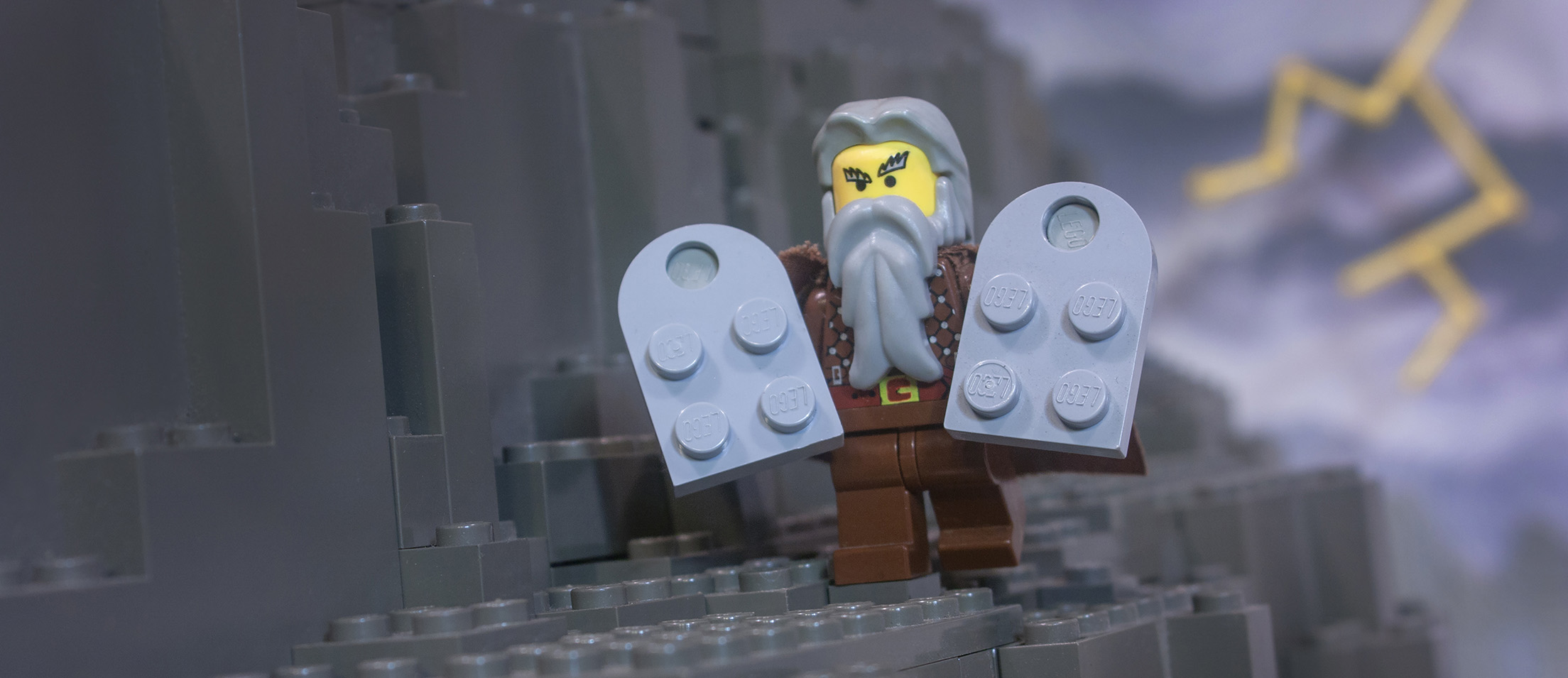 Moses, carrying the two tables of the Ten Commandments, is depicted using LEGO bricks.