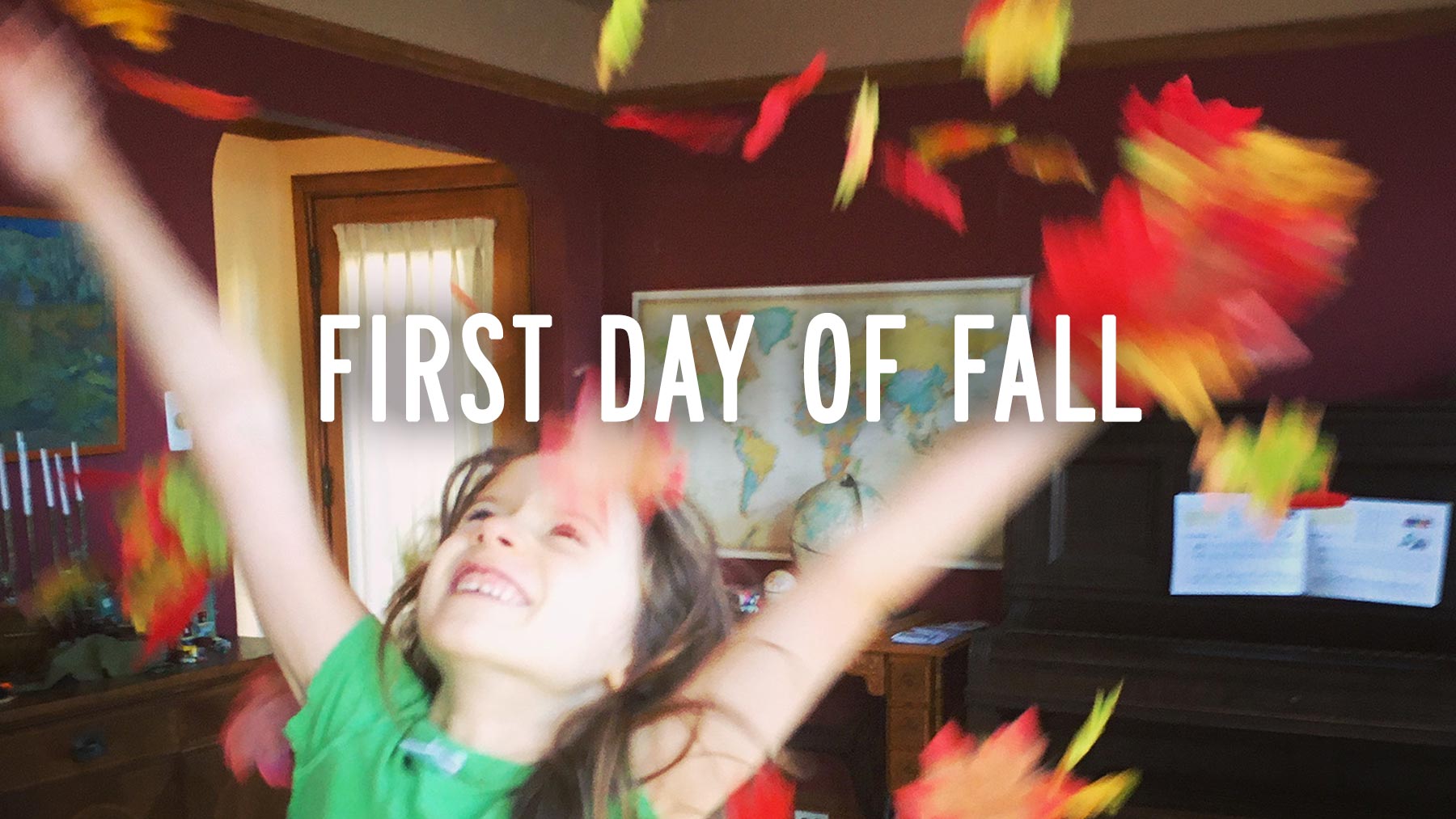 Wanda in our living room, throwing colorful fall leaves over her head.