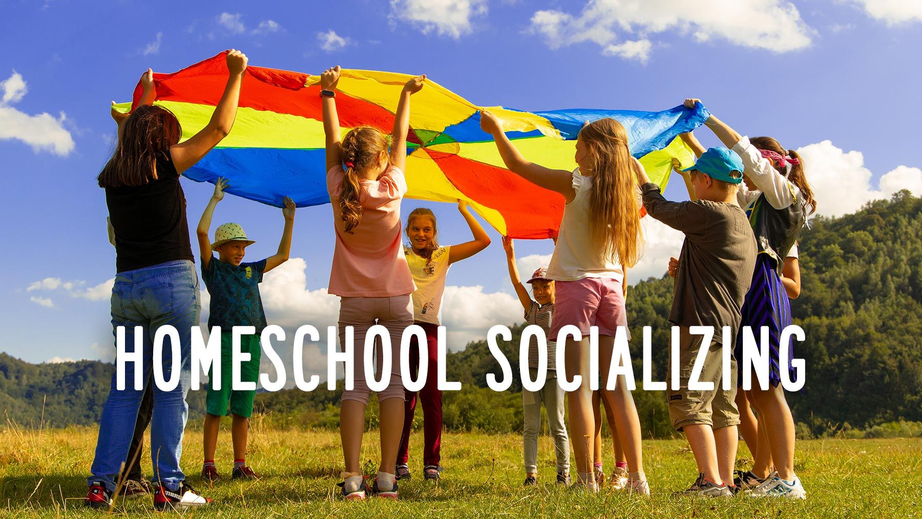 A dozen kids in a circle, holding the edges of a colorful parachute high over their heads.