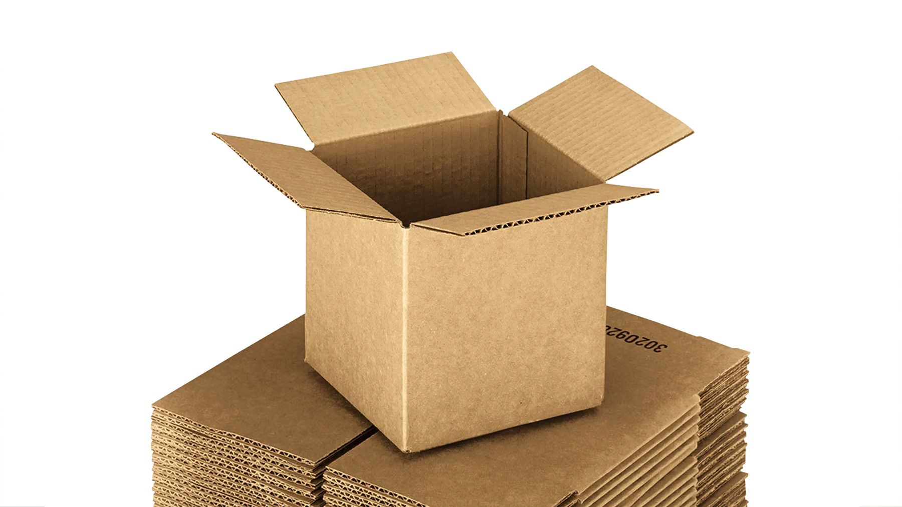 An open cardboard box atop a stack of flattened cardboard boxes.