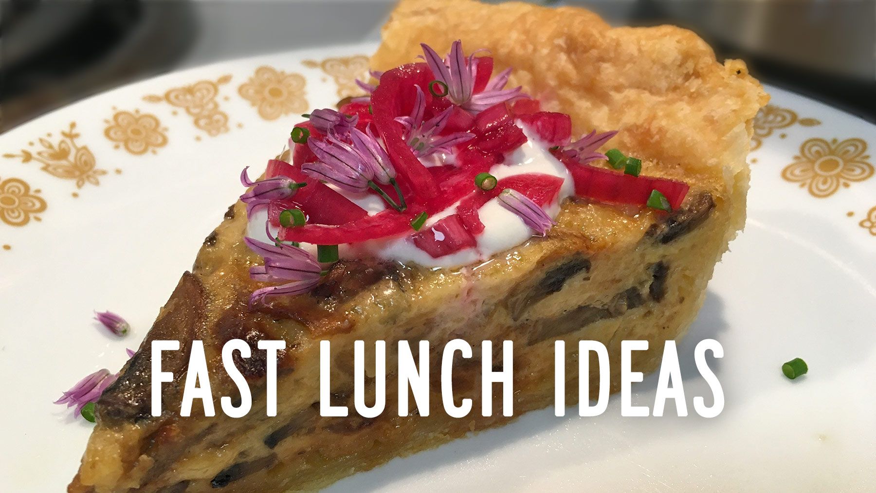A slice of quiche is topped with bright pink onions and small purple blossoms, with the words FAST LUNCH IDEAS.