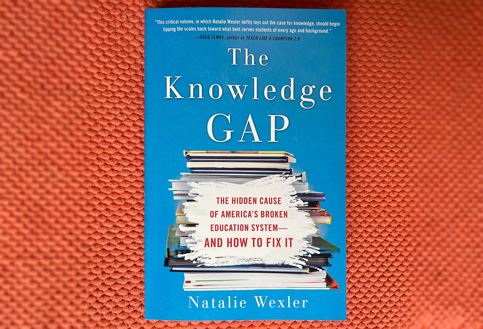 The cover of The Knowledge Gap, on an orange background.