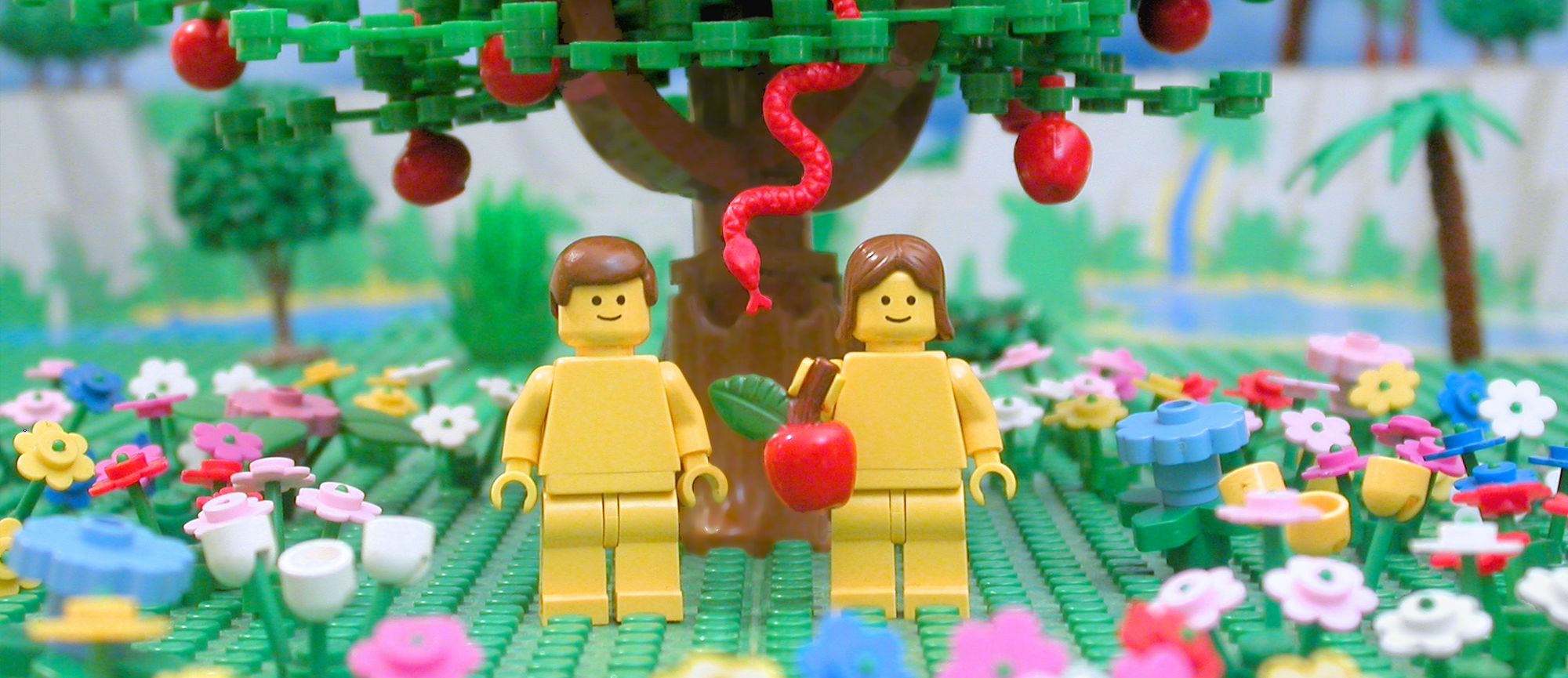 Adam and Eve in the Garden of Eden are depicted using LEGO bricks.