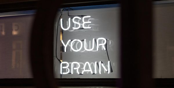 Neon sign that says, "USE YOUR BRAIN"